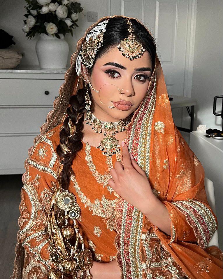 Mehndi bride with a thick dressed side braid