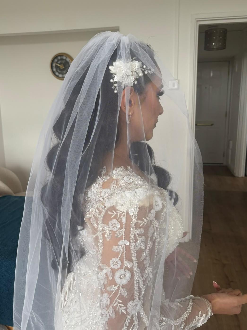 Back view of a bride with a floral hairpiece set under a full veil