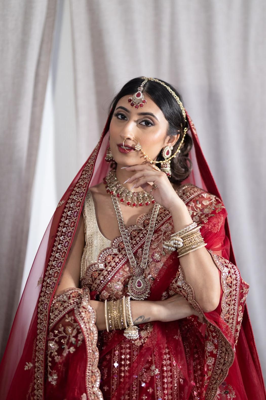 Bride with a centre-parted low bun and layered gold headpiece