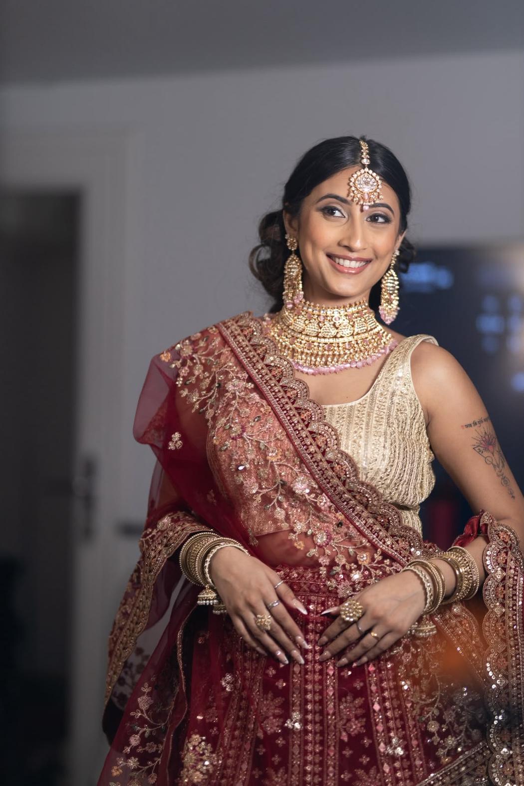 Bride with a low bun and gold maang tikka